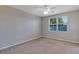 Bedroom with a ceiling fan, natural light from the window, and neutral carpet at 1306 Windward Oaks Loop, Auburndale, FL 33823