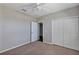 Bedroom with ceiling fan, closet, and access to en-suite at 1306 Windward Oaks Loop, Auburndale, FL 33823