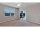 Bedroom with carpet floors and sliding glass door with backyard view at 1306 Windward Oaks Loop, Auburndale, FL 33823