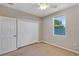 Bedroom with carpet floors, a ceiling fan, and a window at 1306 Windward Oaks Loop, Auburndale, FL 33823