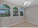 The dining room features tile flooring, a chandelier, and three large windows with lots of sunlight at 1306 Windward Oaks Loop, Auburndale, FL 33823