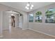 The dining room offers tile flooring, a chandelier, and three large windows with lots of sunlight at 1306 Windward Oaks Loop, Auburndale, FL 33823