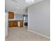 View of the kitchen showcasing tile flooring, wooden cabinets, granite countertops, and stainless steel dishwasher at 1306 Windward Oaks Loop, Auburndale, FL 33823