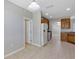 Open concept kitchen featuring tile flooring, wooden cabinets, and white appliances at 1306 Windward Oaks Loop, Auburndale, FL 33823