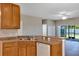 The kitchen offers wood cabinets, laminate countertops, and appliances at 1306 Windward Oaks Loop, Auburndale, FL 33823