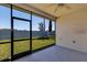 Enclosed patio featuring a ceiling fan and open views of the landscaped backyard at 1306 Windward Oaks Loop, Auburndale, FL 33823