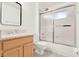 Bathroom featuring a tiled tub and shower combination with sliding glass doors and light-stained wood vanity at 1341 American Elm Dr, Altamonte Springs, FL 32714