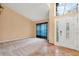 Inviting foyer featuring a decorative glass door and sidelights, along with soaring ceilings and tile flooring at 1341 American Elm Dr, Altamonte Springs, FL 32714