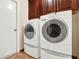 Convenient laundry area with modern washer and dryer units and wooden cabinets above at 1341 American Elm Dr, Altamonte Springs, FL 32714