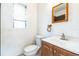 Bathroom with a sink, a toilet, and a mirror at 1408 N Pine Hills Rd, Orlando, FL 32808