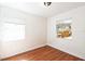 Bedroom with hardwood floors, white walls, and windows at 1408 N Pine Hills Rd, Orlando, FL 32808