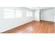 Bedroom featuring hardwood floors, white walls, and multiple windows at 1408 N Pine Hills Rd, Orlando, FL 32808