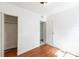 Bedroom featuring hardwood floors, white walls, and a closet at 1408 N Pine Hills Rd, Orlando, FL 32808