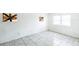 Bedroom with white walls, tile floors, and boarded windows at 1408 N Pine Hills Rd, Orlando, FL 32808