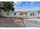 Modest single-story home featuring a light-colored exterior and a small front yard at 1408 N Pine Hills Rd, Orlando, FL 32808