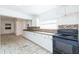 Bright kitchen features white cabinetry, tile backsplash, and modern black appliances at 1408 N Pine Hills Rd, Orlando, FL 32808