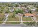 An aerial view of a neighborhood with a lake in the distance, featuring mature trees and single-Gathering homes at 1417 Independence Ave, Deltona, FL 32725