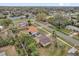 An aerial view of a residential neighborhood with a street intersection and mature trees at 1417 Independence Ave, Deltona, FL 32725