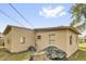 Exterior shot of a backyard featuring a partially covered tree stump and an AC unit at 1417 Independence Ave, Deltona, FL 32725