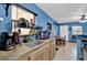 A practical kitchen featuring a stylish faucet, wooden cabinets, and views into the open-concept dining area at 1417 Independence Ave, Deltona, FL 32725