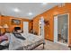 Bright main bedroom featuring vibrant orange walls and a large bed with neutral colored bedding at 1417 Independence Ave, Deltona, FL 32725