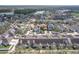 Aerial view of residential community with lake in the background at 14472 Chinese Elm Dr, Orlando, FL 32828