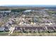 Aerial view of homes in a planned community with a lake in the distance at 14472 Chinese Elm Dr, Orlando, FL 32828