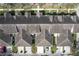 Aerial view of townhomes showing roof lines, driveways, and mature trees at 14472 Chinese Elm Dr, Orlando, FL 32828