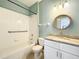 Bathroom with white tile, a shower and tub, and a sink with a marble countertop at 14472 Chinese Elm Dr, Orlando, FL 32828