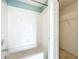 Bright bathroom with a white tiled shower-tub combo and a storage area at 14472 Chinese Elm Dr, Orlando, FL 32828