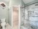 Bathroom featuring a tiled shower and open door to a walk-in closet with shelving at 14472 Chinese Elm Dr, Orlando, FL 32828