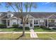 Attractive townhouse featuring a well-manicured lawn, lush landscaping, and inviting curb appeal at 14472 Chinese Elm Dr, Orlando, FL 32828