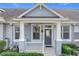 Inviting front porch with white railings and ceiling fan, creating a welcoming entrance at 14472 Chinese Elm Dr, Orlando, FL 32828