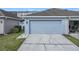 One-car garage with concrete driveway; some items visible in the neighboring open garage at 14472 Chinese Elm Dr, Orlando, FL 32828