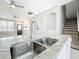 Kitchen area with stainless steel sink and access to the living room and stairs at 14472 Chinese Elm Dr, Orlando, FL 32828