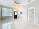 Inviting living room featuring a ceiling fan, large window, and ceramic tile floors at 14472 Chinese Elm Dr, Orlando, FL 32828