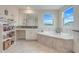 This bathroom features a soaking tub, grey tile accents, white vanity, and large mirror at 1472 Rushing Rapids Way, Winter Springs, FL 32708