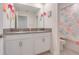 Bathroom features dual sinks, white cabinets, and shower/tub combo with rose-themed curtain at 1472 Rushing Rapids Way, Winter Springs, FL 32708