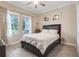 Comfortable bedroom with neutral tones, two windows, and a cozy bed at 1472 Rushing Rapids Way, Winter Springs, FL 32708