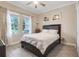Comfortable bedroom with a ceiling fan, two windows, and tiled floors provides lots of natural light at 1472 Rushing Rapids Way, Winter Springs, FL 32708