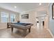 Spacious billiard room with a pool table, large windows, and stylish flooring at 1472 Rushing Rapids Way, Winter Springs, FL 32708