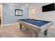 Chic billiard room featuring a blue pool table, modern lighting, and contemporary decor at 1472 Rushing Rapids Way, Winter Springs, FL 32708