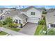 Beautiful two-story home featuring a covered porch with stone accents, a brick driveway, and a two-car garage at 1472 Rushing Rapids Way, Winter Springs, FL 32708