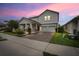 Charming two-story home featuring a well-manicured lawn and a welcoming front porch with stone detailing at 1472 Rushing Rapids Way, Winter Springs, FL 32708