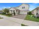 Inviting two-story home with a brick driveway, two-car garage, and a landscaped front yard at 1472 Rushing Rapids Way, Winter Springs, FL 32708