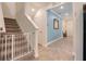 Hallway and carpeted staircase featuring a baby gate and light blue accent wall at 1472 Rushing Rapids Way, Winter Springs, FL 32708