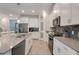 Well-equipped kitchen with stainless steel appliances, gray countertops, and a large island at 1472 Rushing Rapids Way, Winter Springs, FL 32708