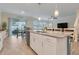 Kitchen island with bar stools, stainless dishwasher and view to outdoor dining at 1472 Rushing Rapids Way, Winter Springs, FL 32708