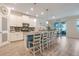 Modern kitchen island features pendant lighting, bar stool seating and stainless appliances at 1472 Rushing Rapids Way, Winter Springs, FL 32708