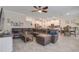 Open-concept living room with a large sectional, dining area, and a clear view into the modern kitchen at 1472 Rushing Rapids Way, Winter Springs, FL 32708